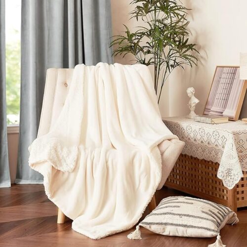 A cozy living room with a large soft gray living room carpet rugs under a sofa and coffee table.