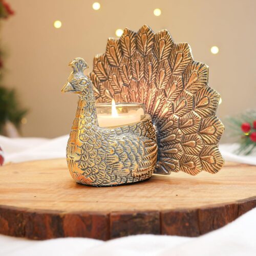 Golden metal candle holder in the shape of a peacock, candle holder featuring intricate feather detailing and a lit candle, perfect for decorative and ambient lighting.Peacock Candle Holder